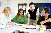 group of people working together at a table